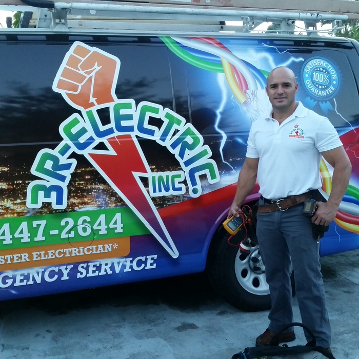 Rey Marrero standing beside his 3R Electric Inc service van